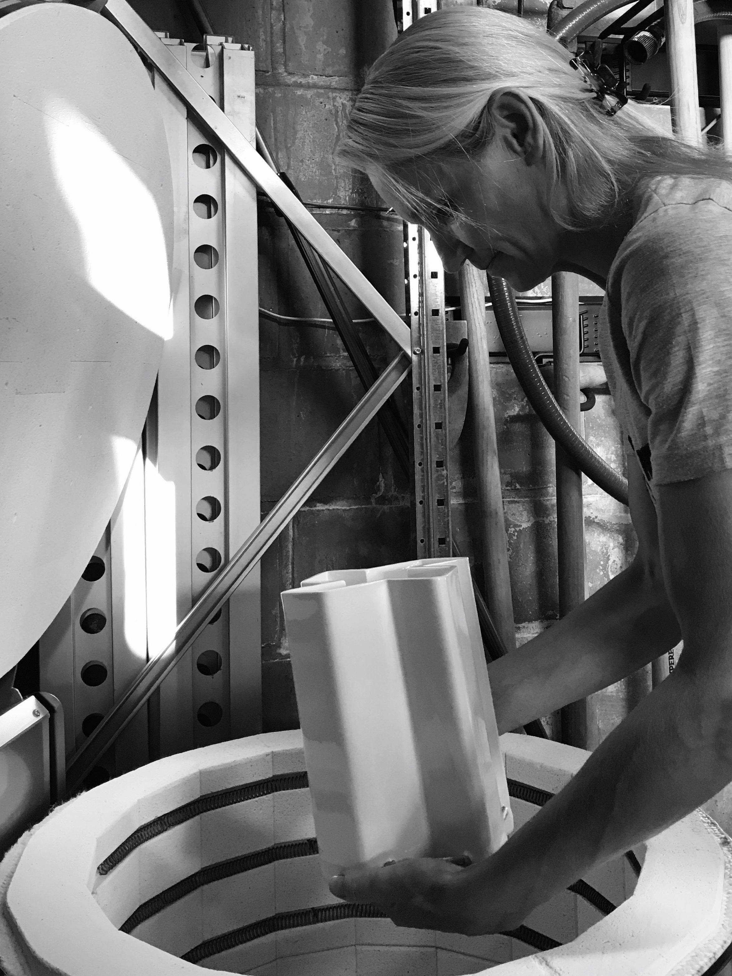 Vicky Courtens unloading a fired ceramic piece from the kiln in the Roeselare laboratory