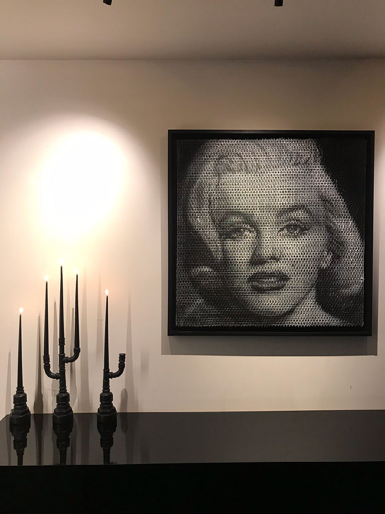 Candle Light — three black ceramic candleholders on a black ledge