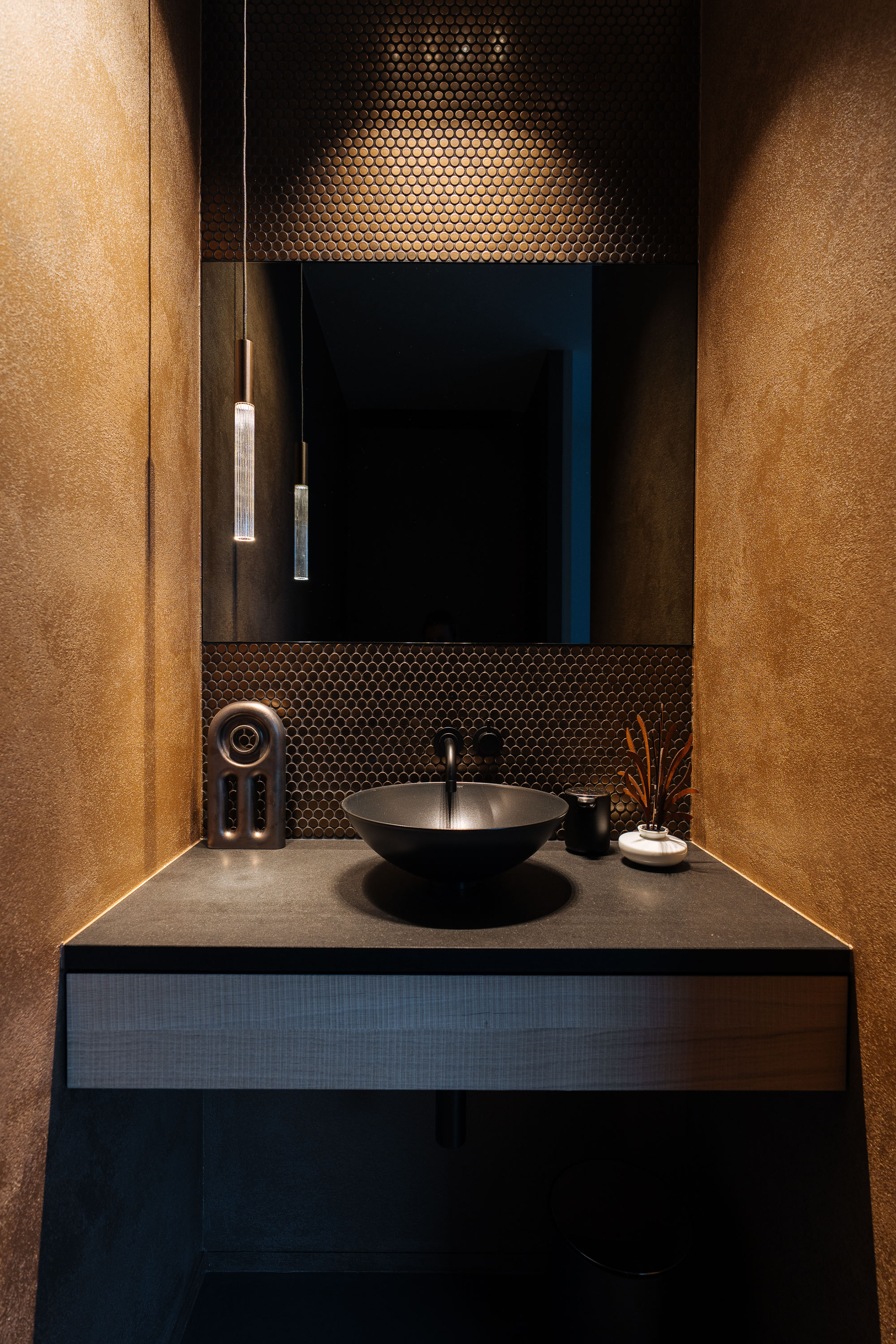 Powder room with bronze ceramic vessel