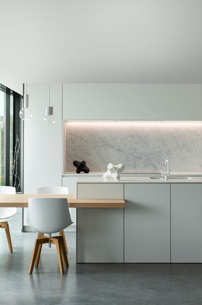 Cadzand piece on a marble counter shelf in a minimalist white kitchen