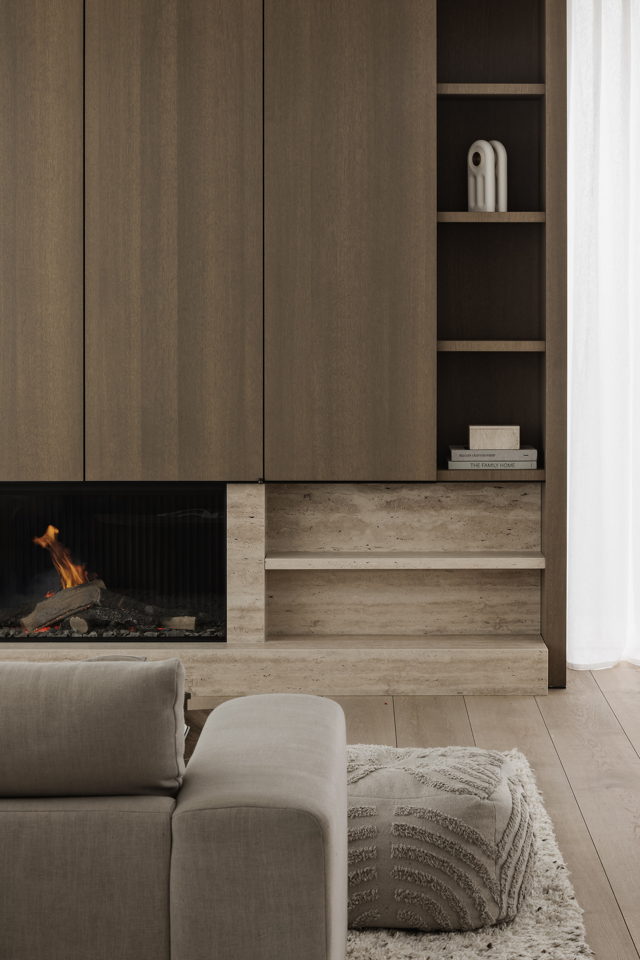 Detail of travertine fireplace shelf with white vessel