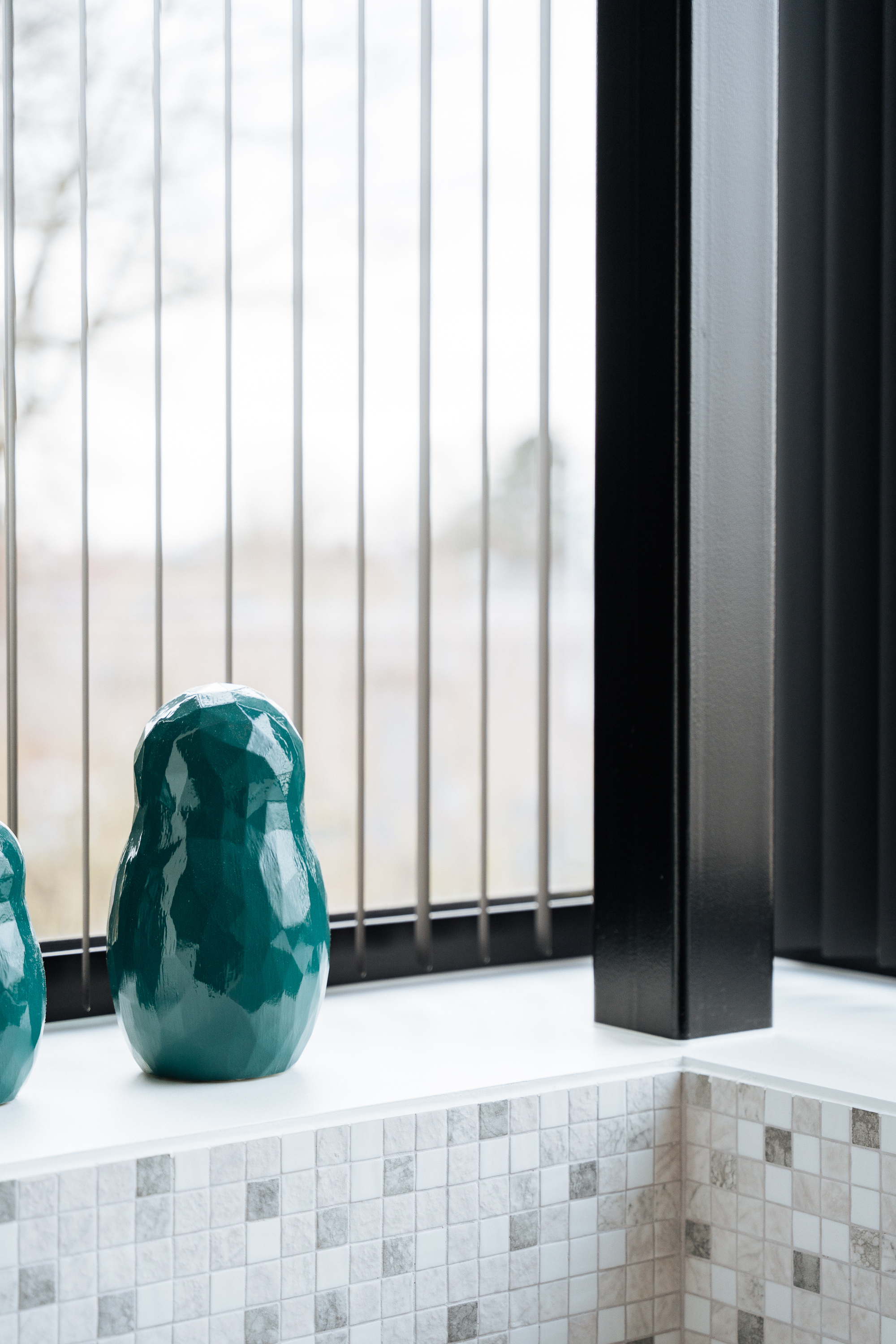 Teal Matroesjka vessels on a window sill